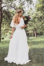 back view of beautiful young bride holding wedding bouquet Royalty Free Stock Photo