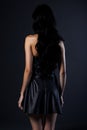 Back view of a beautiful young woman in a black dress. Royalty Free Stock Photo