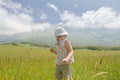 Back view of blonde little girl in Italian Apennines of Abruzzi region looking at mountains