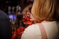 Back view of blonde woman holding a glass with summer cocktail Royalty Free Stock Photo