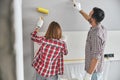 Two professional painters using a roller and a paintbrush Royalty Free Stock Photo