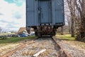 Back view of a blue railroad car on tracks. The car coupler mechanism and undercarriage are rusted. Royalty Free Stock Photo