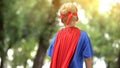 Back view of boy in superman costume, dreamy child, recreational activity