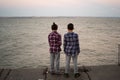Back view of boys fishing at sunset on the river Royalty Free Stock Photo