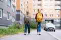 Back view Brother and sister going school after pandemic over. Kids wearing mask and backpacks protect and safety from Royalty Free Stock Photo