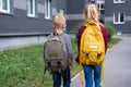 Back view Brother and sister going school after pandemic over. Kids wearing mask and backpacks protect and safety from Royalty Free Stock Photo