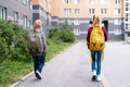 Back view Brother and sister going school after pandemic over. Kids wearing mask and backpacks protect and safety from Royalty Free Stock Photo