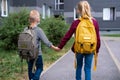 back view Brother and sister going school after pandemic over. Kids wearing mask and backpacks protect and safety from Royalty Free Stock Photo