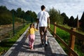 Back view of brother and sister walking on path in the park Royalty Free Stock Photo