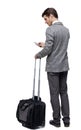 Back view of business man with suitcase with smartphone