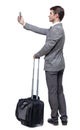 Back view of business man with suitcase with smartphone