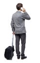 Back view of business man with suitcase talking on the phone Royalty Free Stock Photo