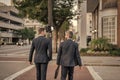 back view of business men coworker outdoor. business men coworker in the street. Royalty Free Stock Photo