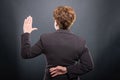 Back view of business senior lady taking fake oath Royalty Free Stock Photo