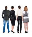 Back view of business team looks at wall. Royalty Free Stock Photo