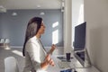 Back view. Business woman brunette meditates at the workplace at the table in the office. Royalty Free Stock Photo