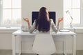 Back view. Business woman brunette meditates at the workplace at the table in the office. Royalty Free Stock Photo