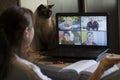 Back view of a business woman talking with her colleagues about an outline in a video conference. Business team using laptop for Royalty Free Stock Photo