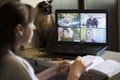 Back view of a business woman talking with her colleagues about an outline in a video conference. Business team using laptop for Royalty Free Stock Photo