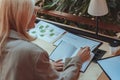 Back view of business woman working with documents and making notes while sitting the desk Royalty Free Stock Photo