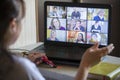 Back view of a business woman talking with her colleagues about an outline in a video conference. Multiethnic business team using Royalty Free Stock Photo