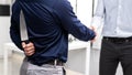 Back view of businessman shaking hands with a knife behind his back. Royalty Free Stock Photo