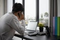 Businessman talking on mobile phone and working on computer laptop at office. Royalty Free Stock Photo