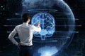 Back view of businessman using creative glowing polygonal brain sphere hologram on blurry background. Neurology research, Royalty Free Stock Photo