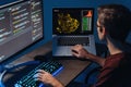 IT developer typing on pc and laptop with programming code on screen, using php language Royalty Free Stock Photo