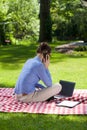 Back view of a busy woman talking on mobile phone in the garden