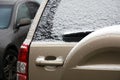 Parked car covered with first snow. Slippery roads, dangerous weather for driving Royalty Free Stock Photo