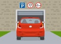 Back view of a car entering parking garage with height and width limit signs. Royalty Free Stock Photo