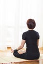 Back View of Caucasian Brunette Woman Practicing Yoga Indoors. Doing Sukhasana Exercises In Physical Lotus Therapy Pose.In Front Royalty Free Stock Photo