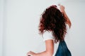 Back view of caucasian woman painting the room walls with white color. Do it yourself and new home concept Royalty Free Stock Photo