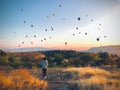 Back view caucasian woman solo traveler walk and watch balloons