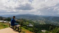 Back view, cheerful young photographer taking a picture with a mobile phone on the mountain Travel Ideas and Travel Lifestyles Royalty Free Stock Photo