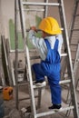 Little boy climbing ladder in apartment under renovation. Royalty Free Stock Photo