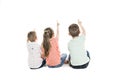 Back view of child group sitting on floor looking at wall Royalty Free Stock Photo