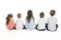 Back view of child group sitting on floor looking at wall Royalty Free Stock Photo