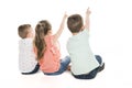 Back view of child group sitting on floor looking at wall Royalty Free Stock Photo