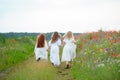 Back view of children playing outdoors. Three girls run moving a Royalty Free Stock Photo