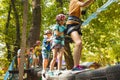 The children are overcoming obstacles in the rope park Royalty Free Stock Photo