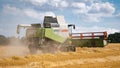 Back view of a CLAAS Combine Harvester harvesting a field.