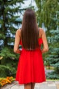Back view close up portrait young beautiful brunette woman in red dress Royalty Free Stock Photo