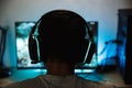 Back view closeup of young gamer boy playing video games online