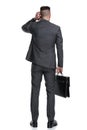 Back view of a confused businessman scratching his head Royalty Free Stock Photo
