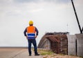 Back view of Construction engineer checking project at the building site, Foreman worker in hardhat at the infrastructure Royalty Free Stock Photo