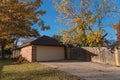 Back view of corner house with attached garage and yard in fall season suburbs Dallas Royalty Free Stock Photo