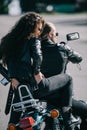 back view of couple of bikers in black leather jackets sitting