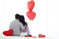 Back view of couple happy Asian lover hugging each other while sitting on white bed, romantic couple celebrate memorable Royalty Free Stock Photo